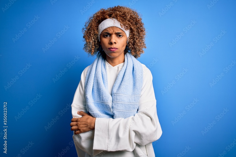 Young african american sportswoman doing sport wearing sportswear and towel skeptic and nervous, disapproving expression on face with crossed arms. Negative person. Young african american sportswoman doing sport wearing sportswear and towel skeptic and nervous, disapproving expression on face with crossed arms. Negative person.