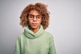 Young beautiful african american woman wearing turtleneck sweater and glasses looking sleepy and tired, exhausted for fatigue and hangover, lazy eyes in the morning.