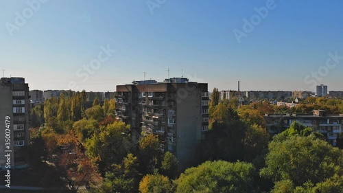 View from the height of the city on the roofs of houses, treesz in the cloudy sky photo