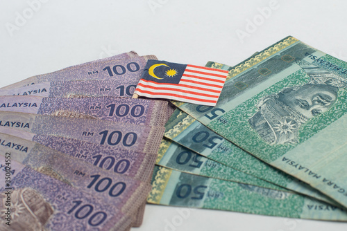 Malaysian 100 Ringgit and 50 Ringgit Notes together with a Malaysian Flag