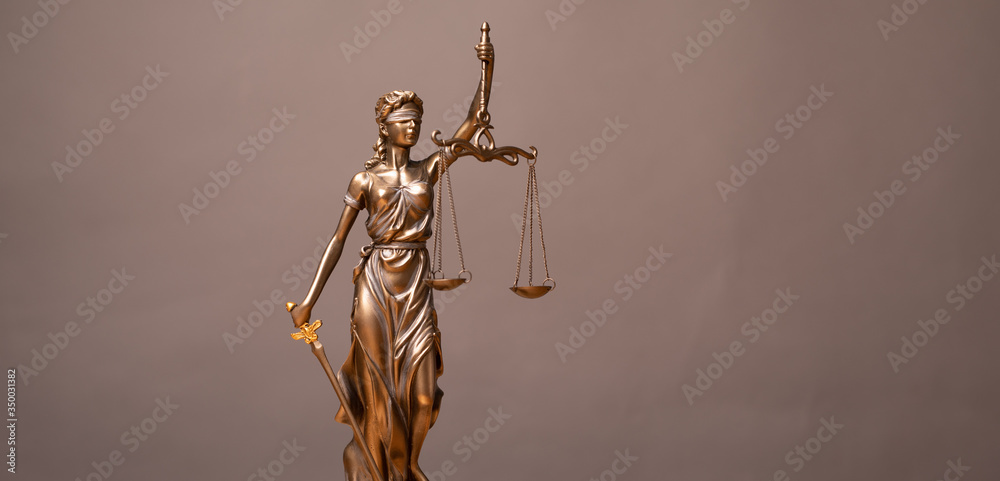 Legal and law concept statue of Lady Justice with scales of justice.