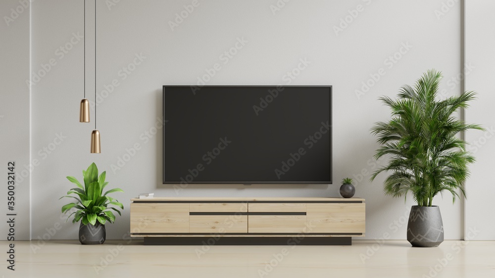 Fototapeta premium Smart TV on the white wall in living room,minimal design.