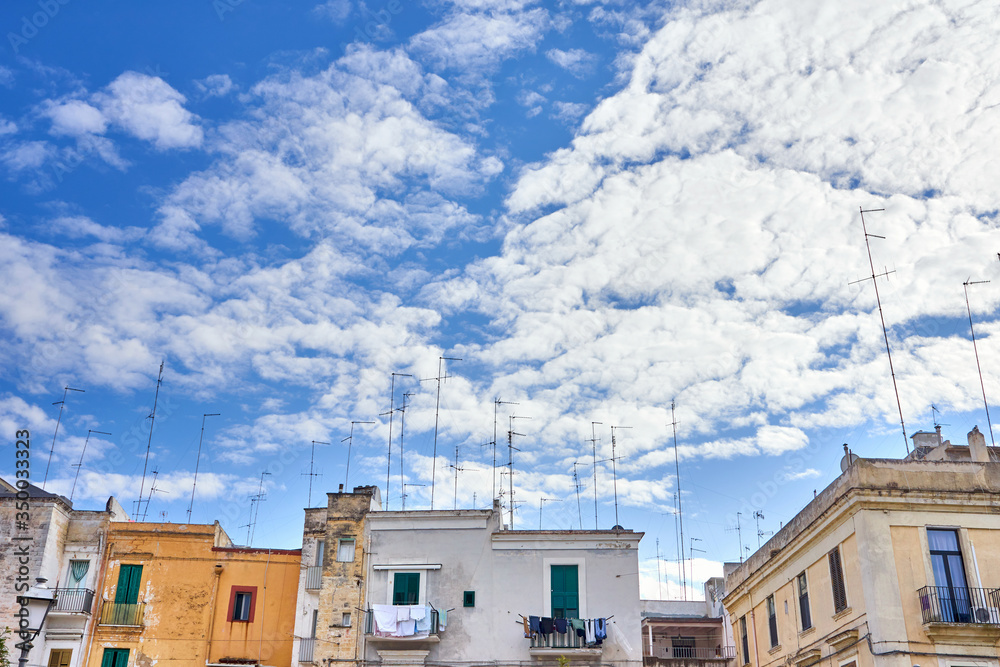 Television and Radio Antennas Fixed On Roofs Of Typical Colorful Houses In Southern Italy