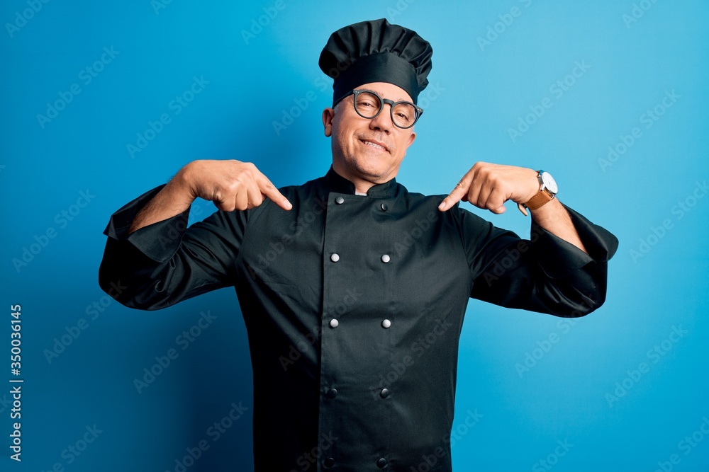 Middle age handsome grey-haired chef man wearing cooker uniform and hat looking confident with smile on face, pointing oneself with fingers proud and happy. Middle age handsome grey-haired chef man wearing cooker uniform and hat looking confident with smile on face, pointing oneself with fingers proud and happy.