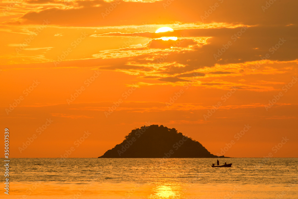 Beautiful sunset with large yellow sun under the sea during sunset time