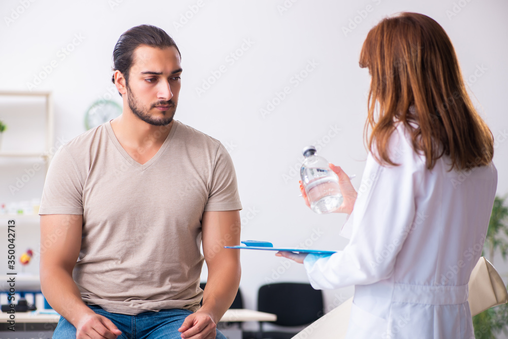 Male diabetic patient visiting young female doctor Male diabetic patient visiting young female doctor