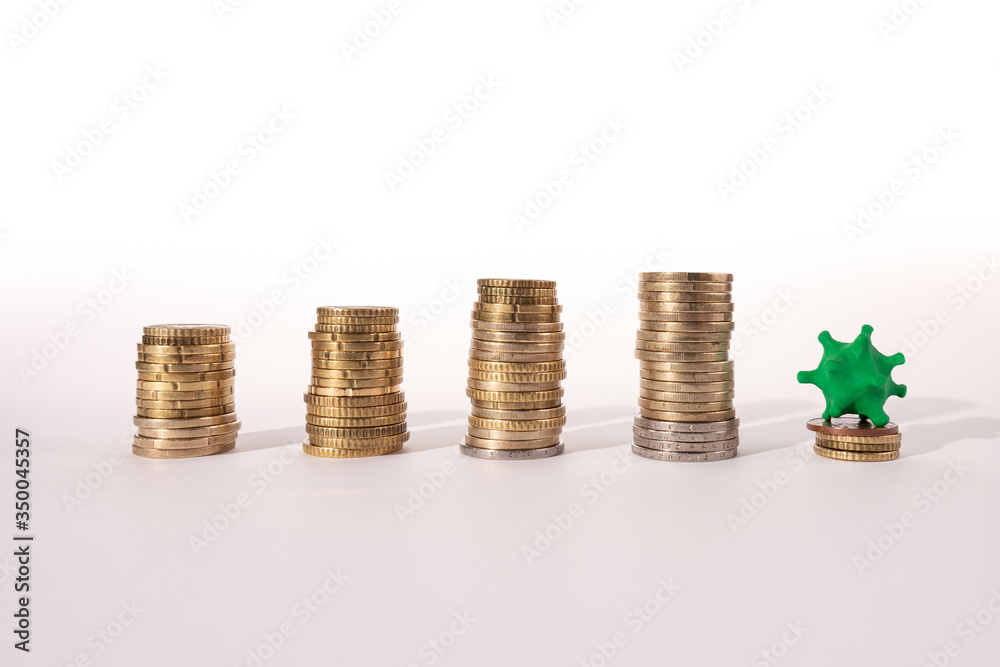 Piles of stacked coins stop growing in size due to the appearance of the covid-19 coronavirus. Conceptual image about the economic crisis. Piles of stacked coins stop growing in size due to the appearance of the covid-19 coronavirus. Conceptual image about the economic crisis.