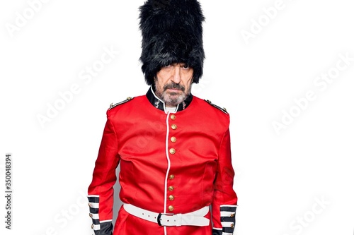 Middle age handsome wales guard man wearing traditional uniform over white background depressed and worry for distress, crying angry and afraid. Sad expression.
