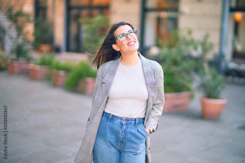 Young beautiful woman smiling happy and confident. Standing with smile on face at the town street Young beautiful woman smiling happy and confident. Standing with smile on face at the town street