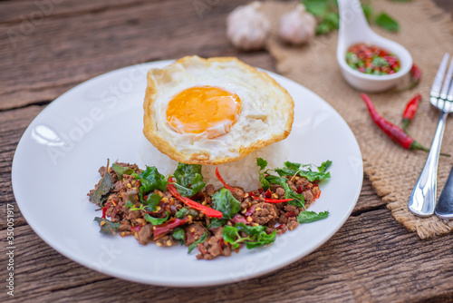 Thai Food Rice topped with egg and stir-fried beef and basil, famous street food in Thailand, fast food, soft focus