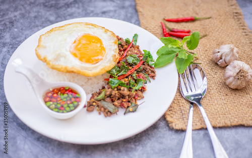 Thai Food Rice topped with egg and stir-fried beef and basil, famous street food in Thailand, fast food, soft focus