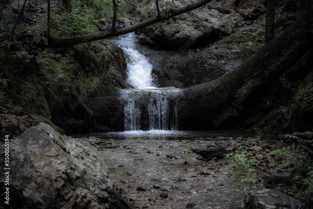 A waterfall with a bright water stream A waterfall with a bright water stream