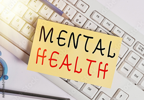 Writing note showing Mental Health. Business concept for an individuals condition regard to their psychological well being White pc keyboard note paper and paper clips above white background