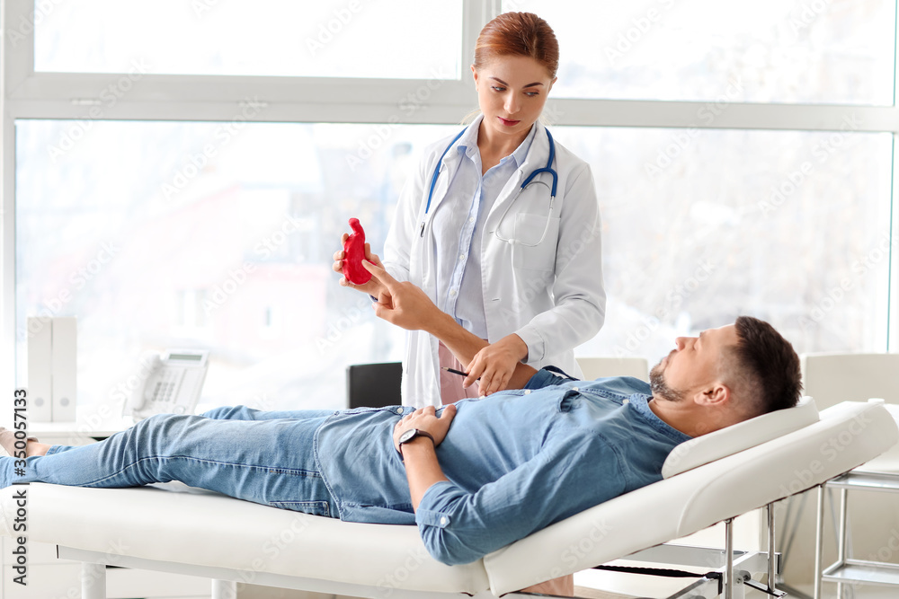 Gastroenterologist examining man in clinic Gastroenterologist examining man in clinic