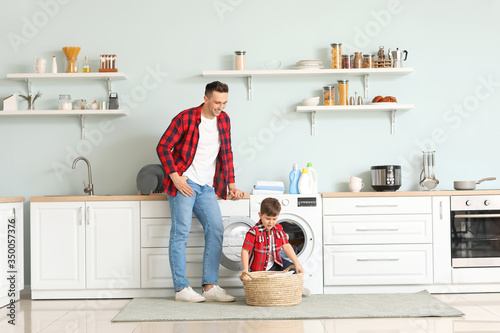 Man and his little son doin...