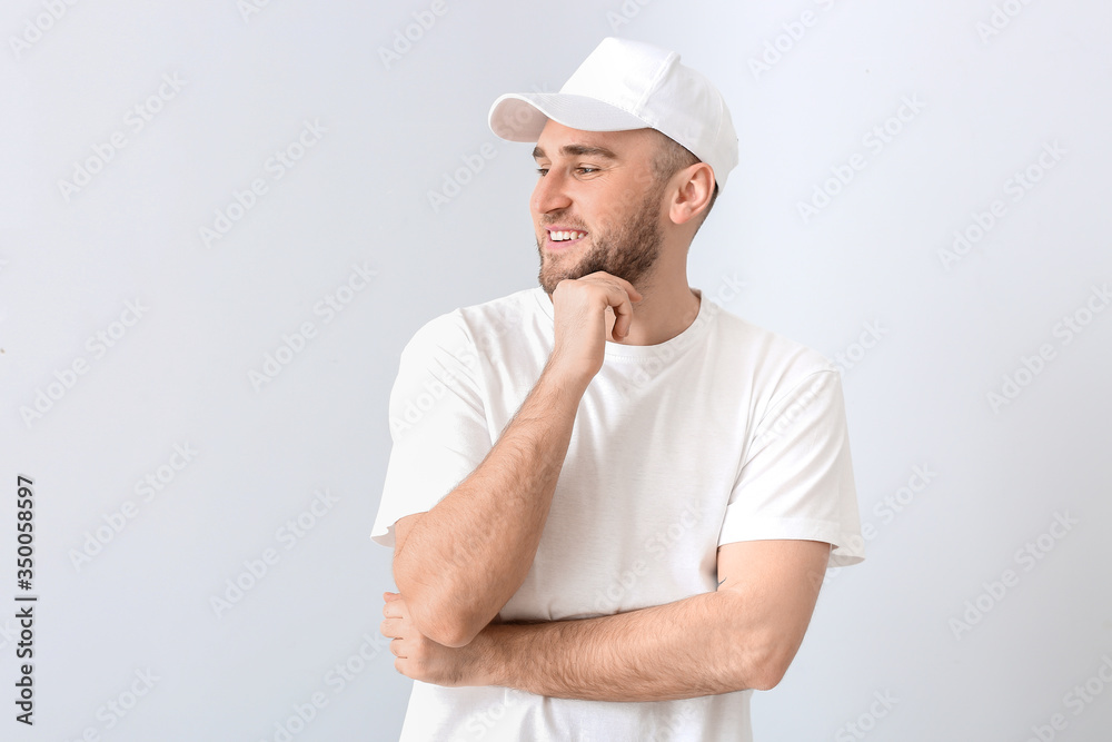 Handsome man in stylish cap on light background Handsome man in stylish cap on light background