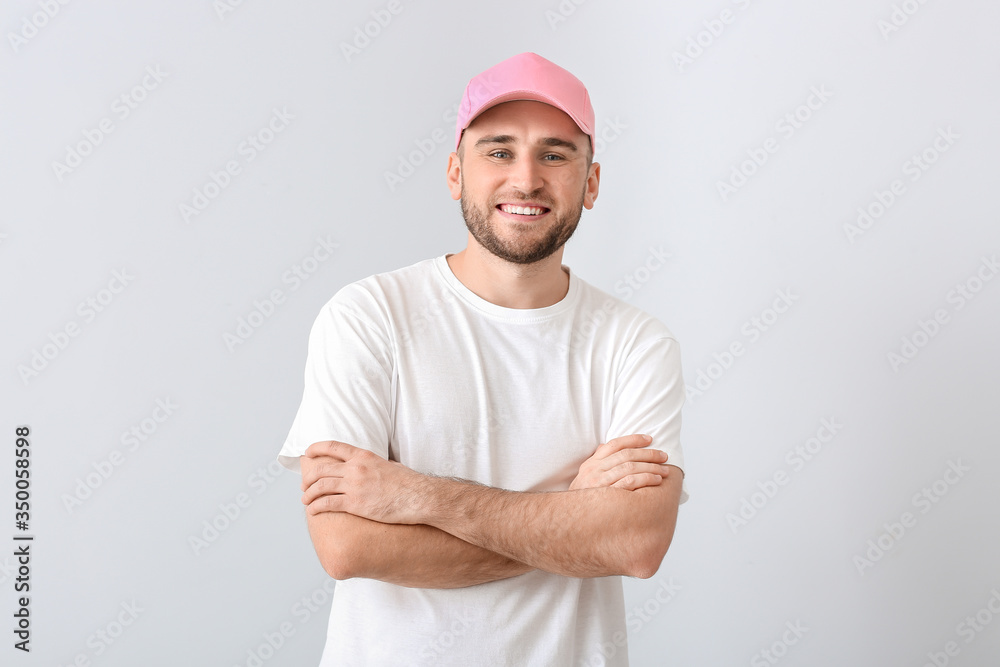 Handsome man in stylish cap on light background Handsome man in stylish cap on light background