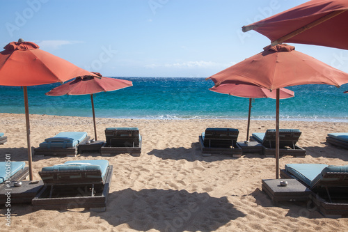 empty beach chairs and umbrella