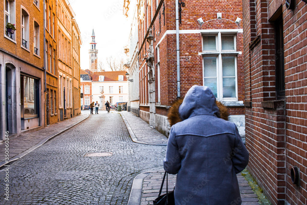 woman walking on street in the old town of Brugges