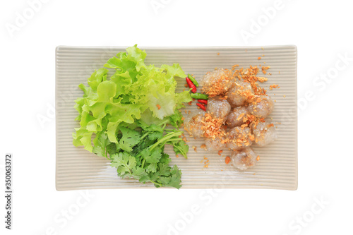 Steamed tapioca balls (Sago) with pork and peanut filling served with vegetable in plate isolated on white background, Famous traditional thai appetizer. photo