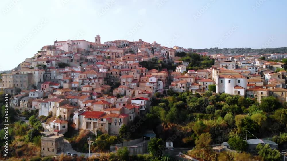 Aerial, rising. drone shot of the Seminara muncipality, bright, blue sky, in Calabria, southern Italy Aerial, rising. drone shot of the Seminara muncipality, bright, blue sky, in Calabria, southern Italy