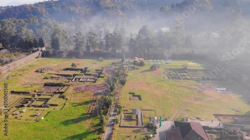 Aerial, tilt up, drone shot  of amoke rising above the Gonio fortress, in Adjara, Georgia photo