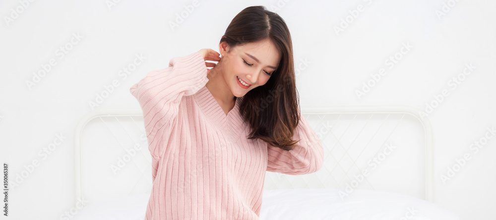 Smiling of cheerful beautiful pretty asian woman clean fresh healthy white skin posing in warm knitted pink clothes.Girl felling relaxing and enjoy time on the bed at home.asia beauty Smiling of cheerful beautiful pretty asian woman clean fresh healthy white skin posing in warm knitted pink clothes.Girl felling relaxing and enjoy time on the bed at home.asia beauty