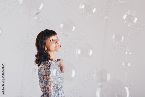 portrait of woman on a white background with glass balls
