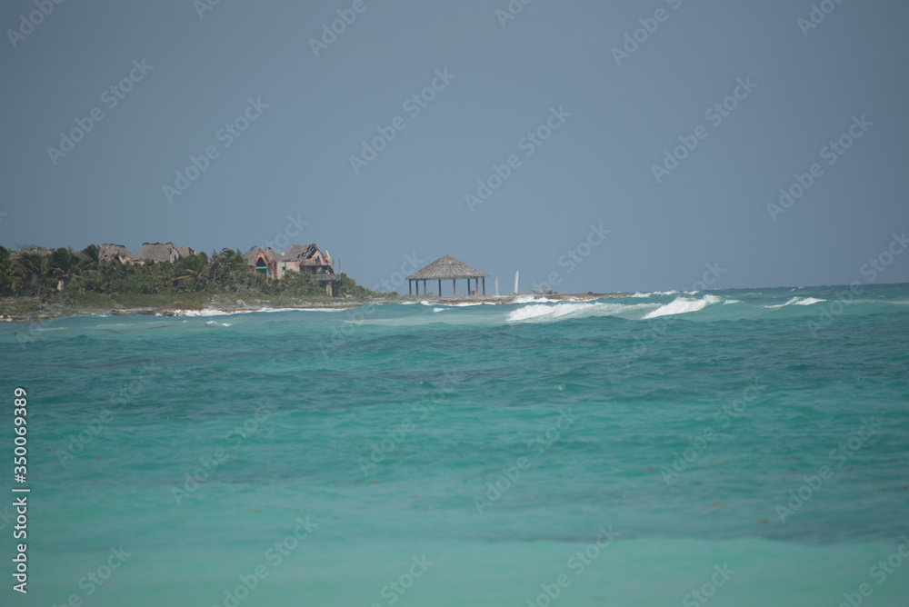 wonderful blue ocean with a cabin at the beach with blue sky