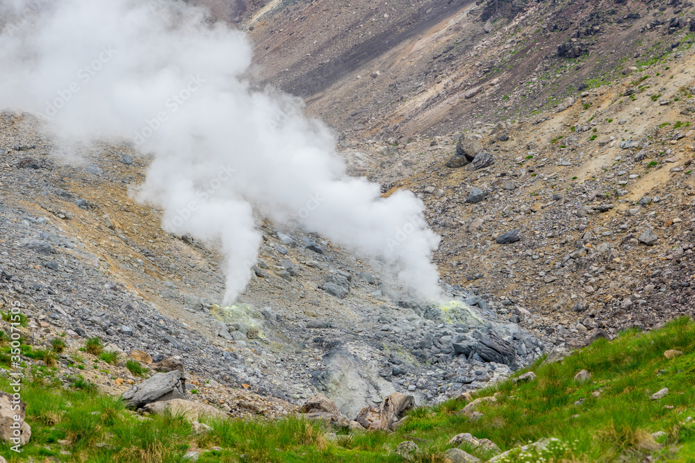 Hot sulfur gases and smoke emitting from underground through fumaroles on  the active volcano Asahidake in summer, Hokkaido, Japan Stock-Foto | Adobe  Stock