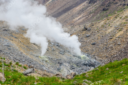 Hot sulfur gases and smoke emitting from underground through fumaroles on the active volcano Asahidake in summer, Hokkaido, Japan