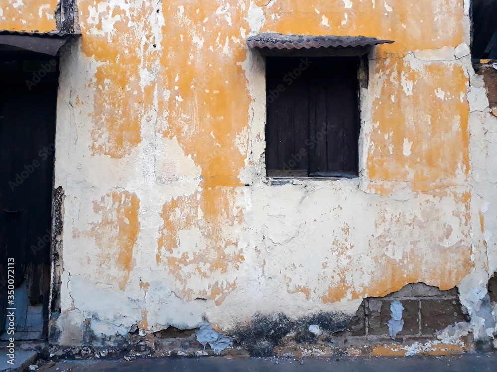 Humble house facade in urban street of Guatemala at sunset, rustic and abandoned construction.
Humble house facade in urban street of Guatemala at sunset, rustic and abandoned construction.