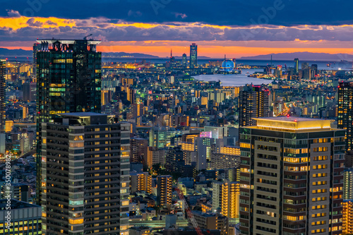 Japan. Evening in Osaka. Sunset in the Japanese city. The business part of Osaka from a height. Office building on background of evening in the city centre of Osaka. Modern urban architecture.