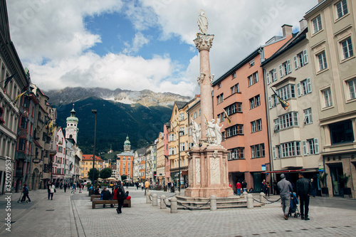 Innsbruck, Austria - 20th September 2015: Maria-Theresien-Strasse (Maria Theresa Street) with the Annasaule (St. Anna's Column), one of the busiest streets in the city of Innsbruck, Tyrol, Austria photo