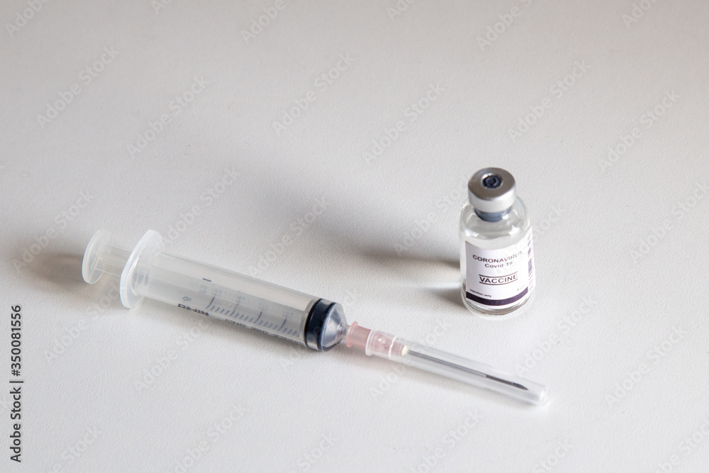 Vaccine and syringe injection on table. Use for prevention,immunization and treatment from corona virus infection novel coronavirus disease,COVID-19,nCoV 2019. Vaccine and syringe injection on table. Use for prevention,immunization and treatment from corona virus infection novel coronavirus disease,COVID-19,nCoV 2019.
