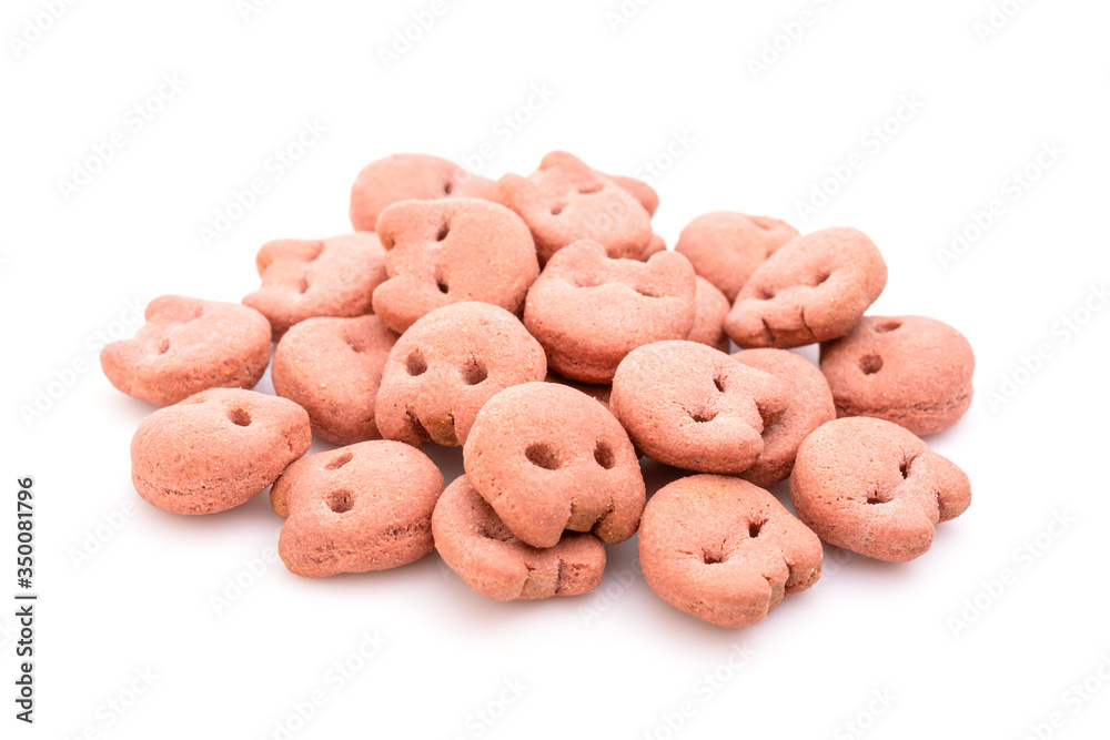 Pile of dog food (pink cookie) grilled beef taste isolated on white Pile of dog food (pink cookie) grilled beef taste isolated on white