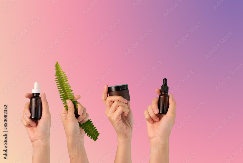 hand hold cosmetic skincare on pink background.beauty banner. hand hold cosmetic skincare on pink background.beauty banner.