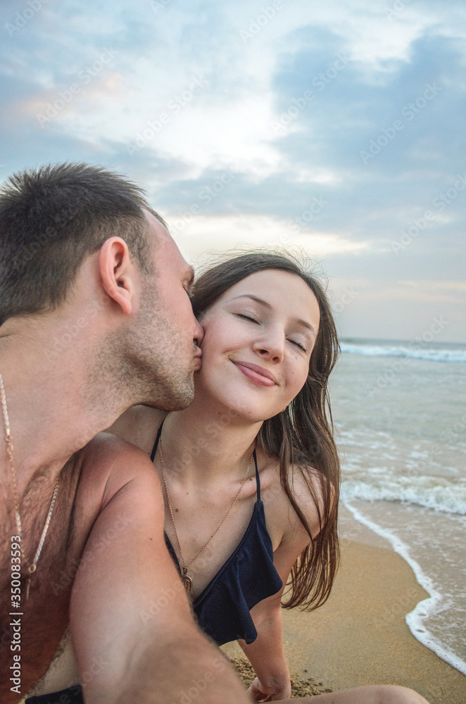 a lovely couple kissing near the sea a lovely couple kissing near the sea