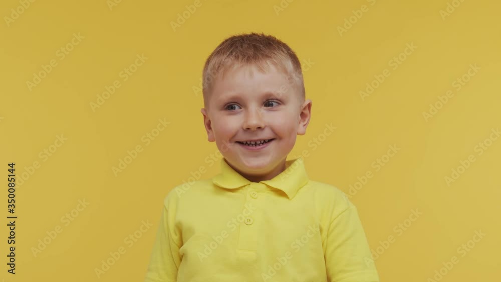 Portrait of happy smiling boy in t-shirt. Attractive and expressive kid in studio. Portrait of happy smiling boy in t-shirt. Attractive and expressive kid in studio.
