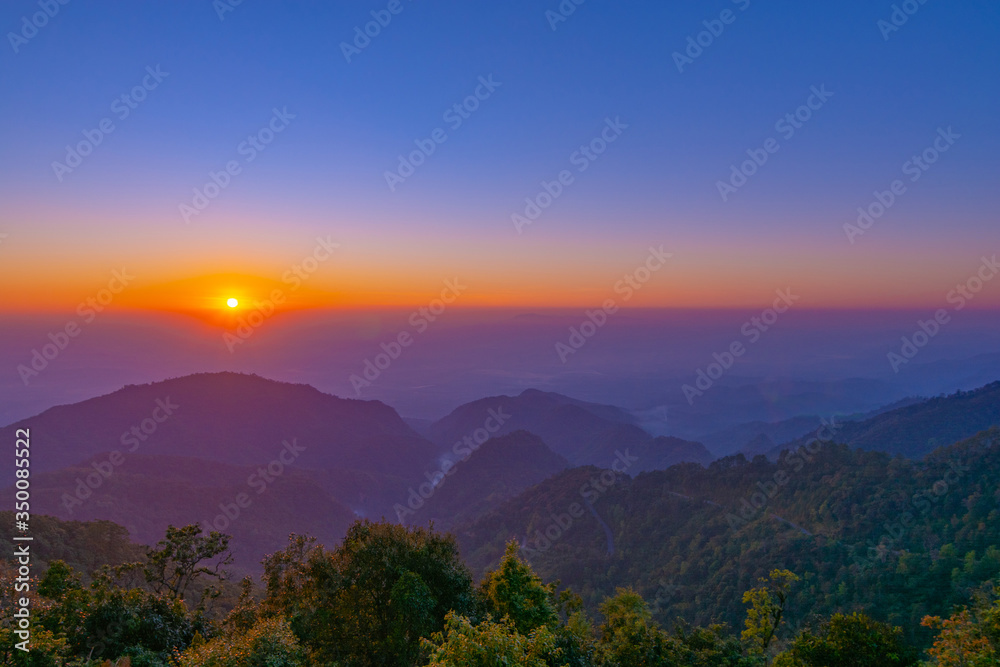 Beautiful golden sunrise and colorful blue sky over the hills and canyons in chiang mai,Thailand