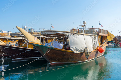 Traditional boats called Dhows are anchored in the port near Museum of Islamic Art Park,Doha, Qatar. © bennnn