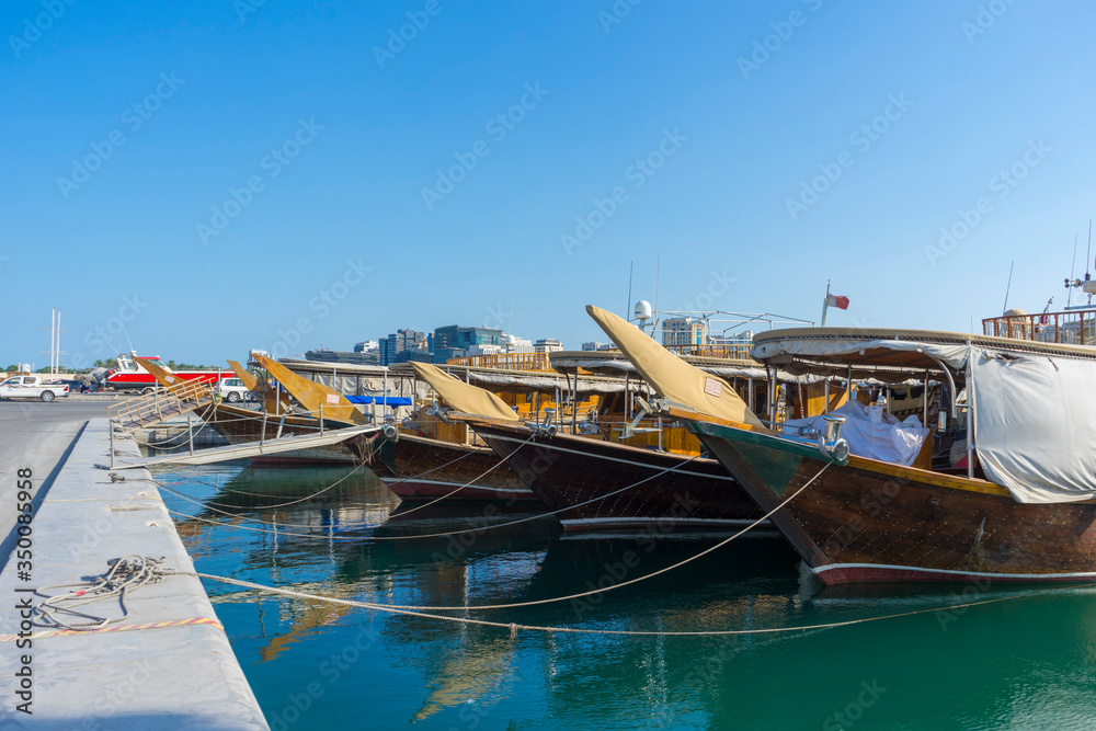 Traditional boats called Dhows are anchored in the port near Museum of Islamic Art Park,Doha, Qatar.
