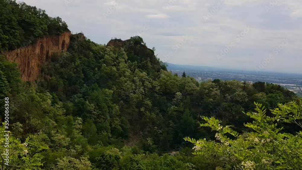 Static view of beautiful rock wall mountain with cities in the distance, Dossenheim Germany. Static view of beautiful rock wall mountain with cities in the distance, Dossenheim Germany.