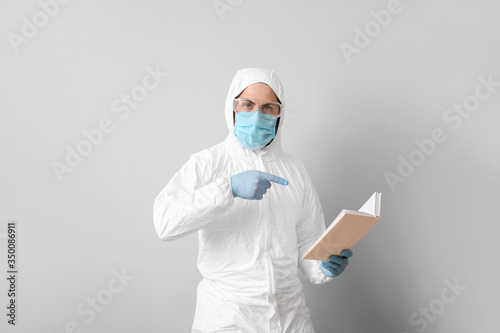 Man in biohazard suit readi...