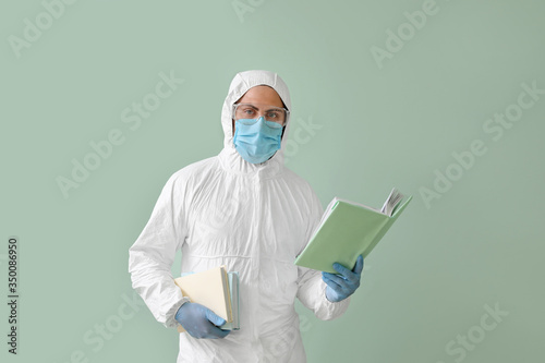 Man in biohazard suit readi...