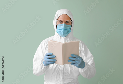 Man in biohazard suit readi...