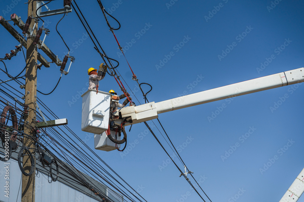 maintenance of electricians work with high voltage electricity on the hydraulic bucket