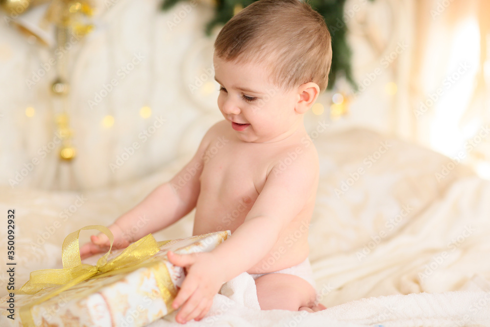 little happy kid unwraps or opens boxes with gifts, surprises little happy kid unwraps or opens boxes with gifts, surprises