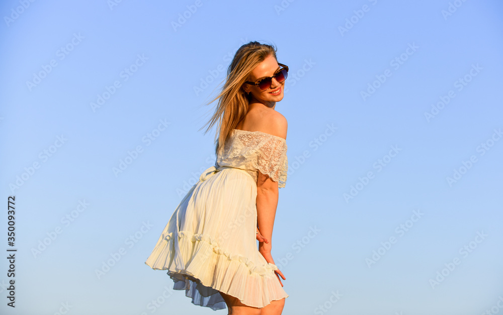Obraz premium Impulsiveness and ease. Naturalness concept. Dancing woman. Mental health. Emotional girl. Happy girl white dress feel free. Summer party. Sunny day. Carefree girl. Freedom. Girl blue sky background