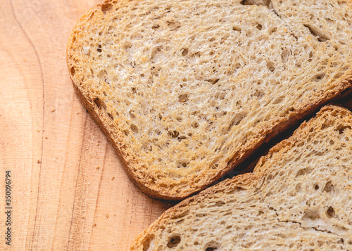 Wholemeal toast ( torrada integral ) in close-up on a wooden object. photo